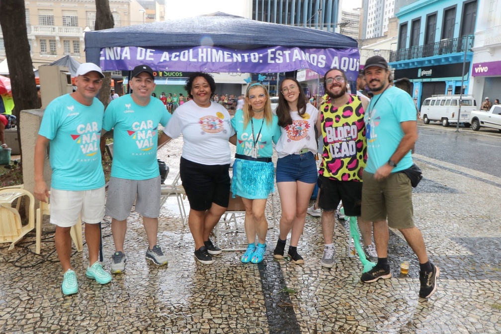 Grupo sorri em frente à tenda Carnaval Sem Assédio no Largo do Rosário, Campinas, durante ação de conscientização.