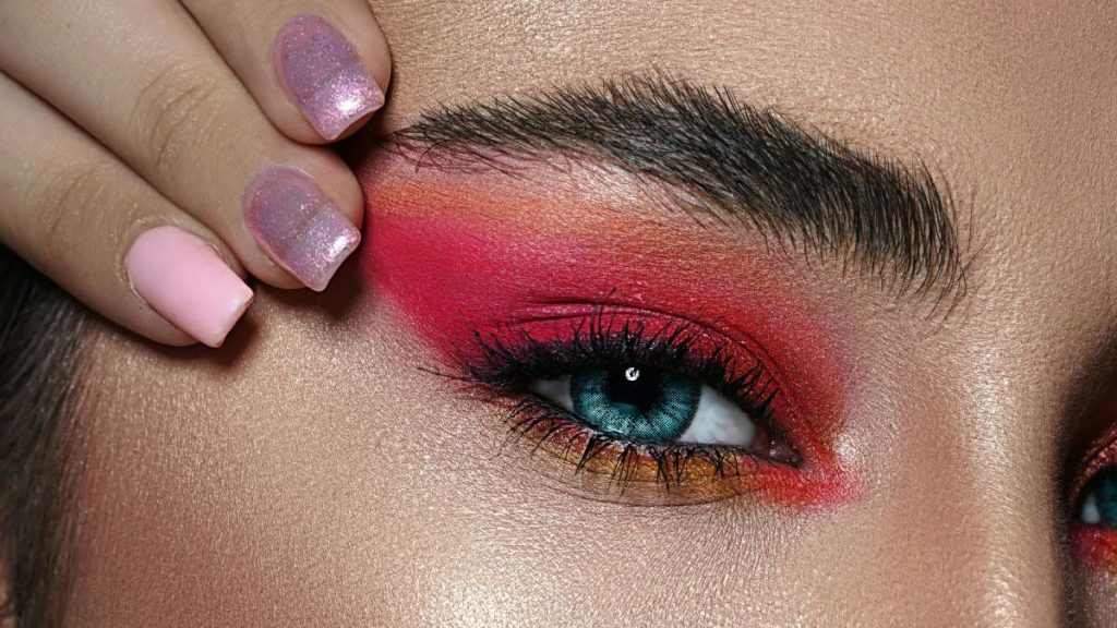 Maquiagem para o carnaval 2026 com sombras vibrantes, pedrarias nos olhos, delineado gráfico e pele iluminada.