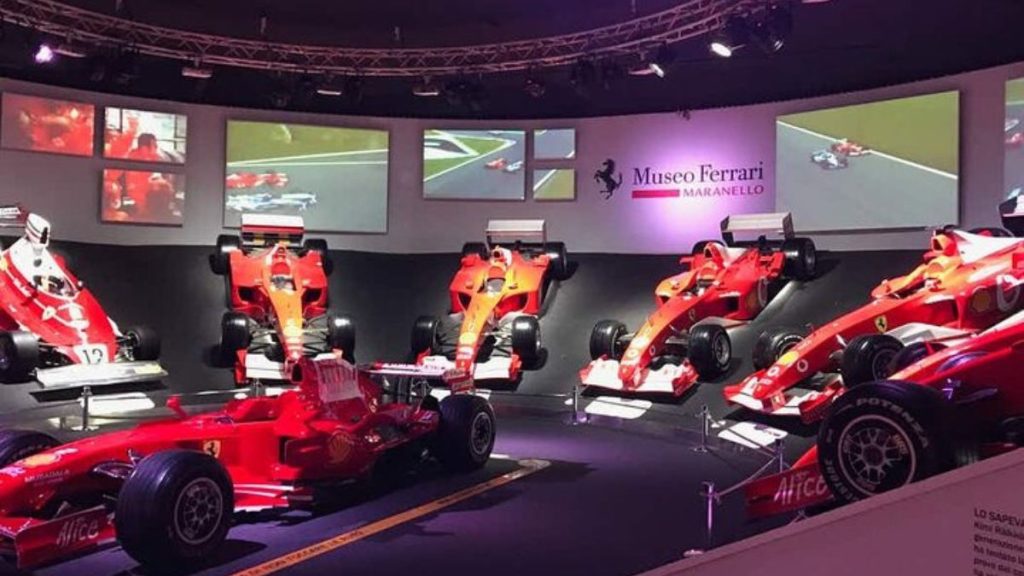 Carros esportivos icônicos expostos no Museu Ferrari, simbolizando a paixão por carros e design italiano de performance.