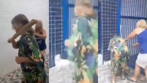 Idosa agredindo cachorra com pedaço de madeira em frente a escola em Praia Grande, litoral de São Paulo.