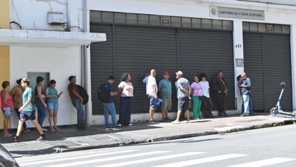Eleitor realizando cadastro eleitoral em cartório da Justiça Eleitoral paulista para as próximas eleições.